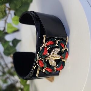 Black Open Cuff Bracelet with Gold Bee Emblem